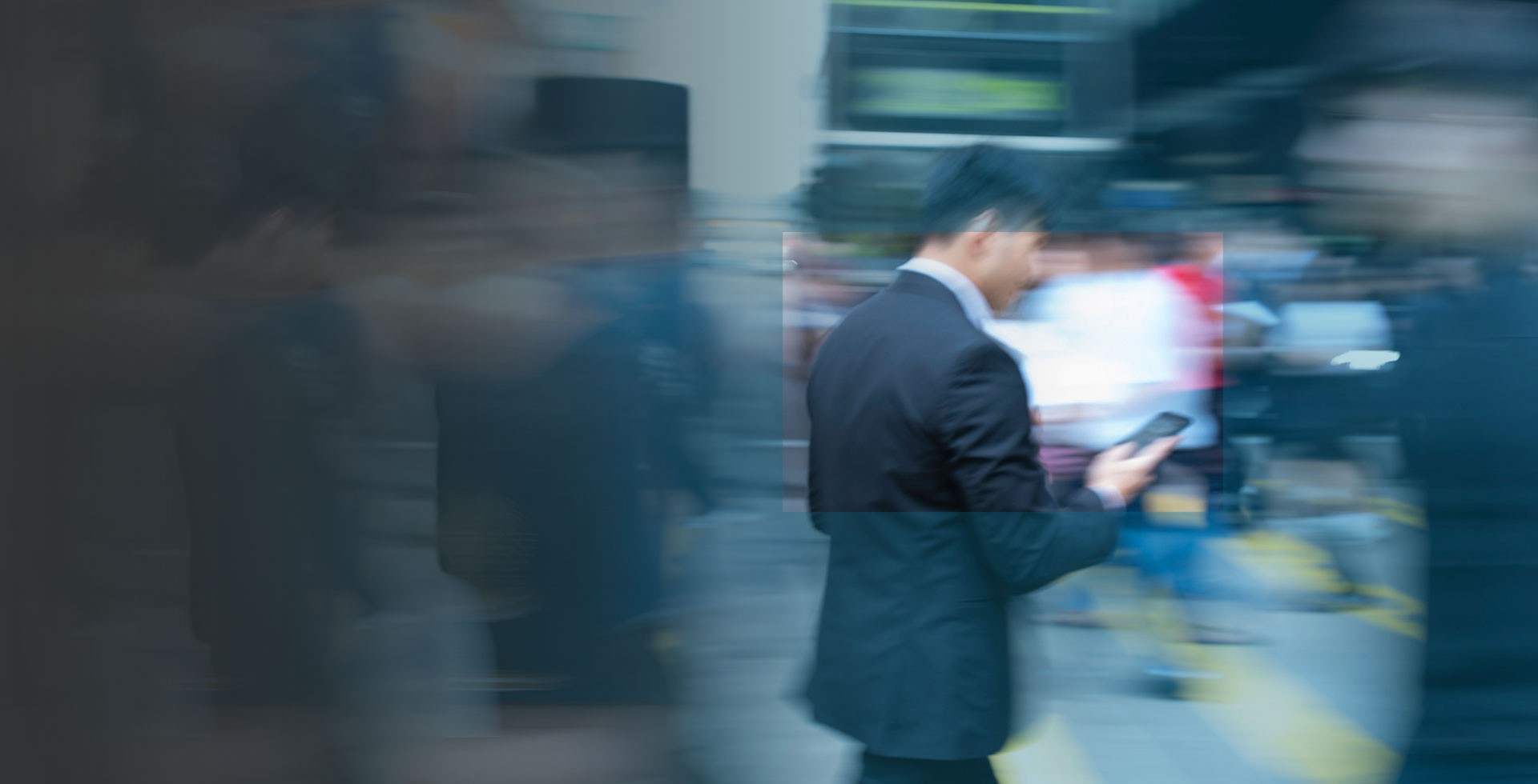 BussinesMan with mobile device in city centre with blurred backround ACTIVE