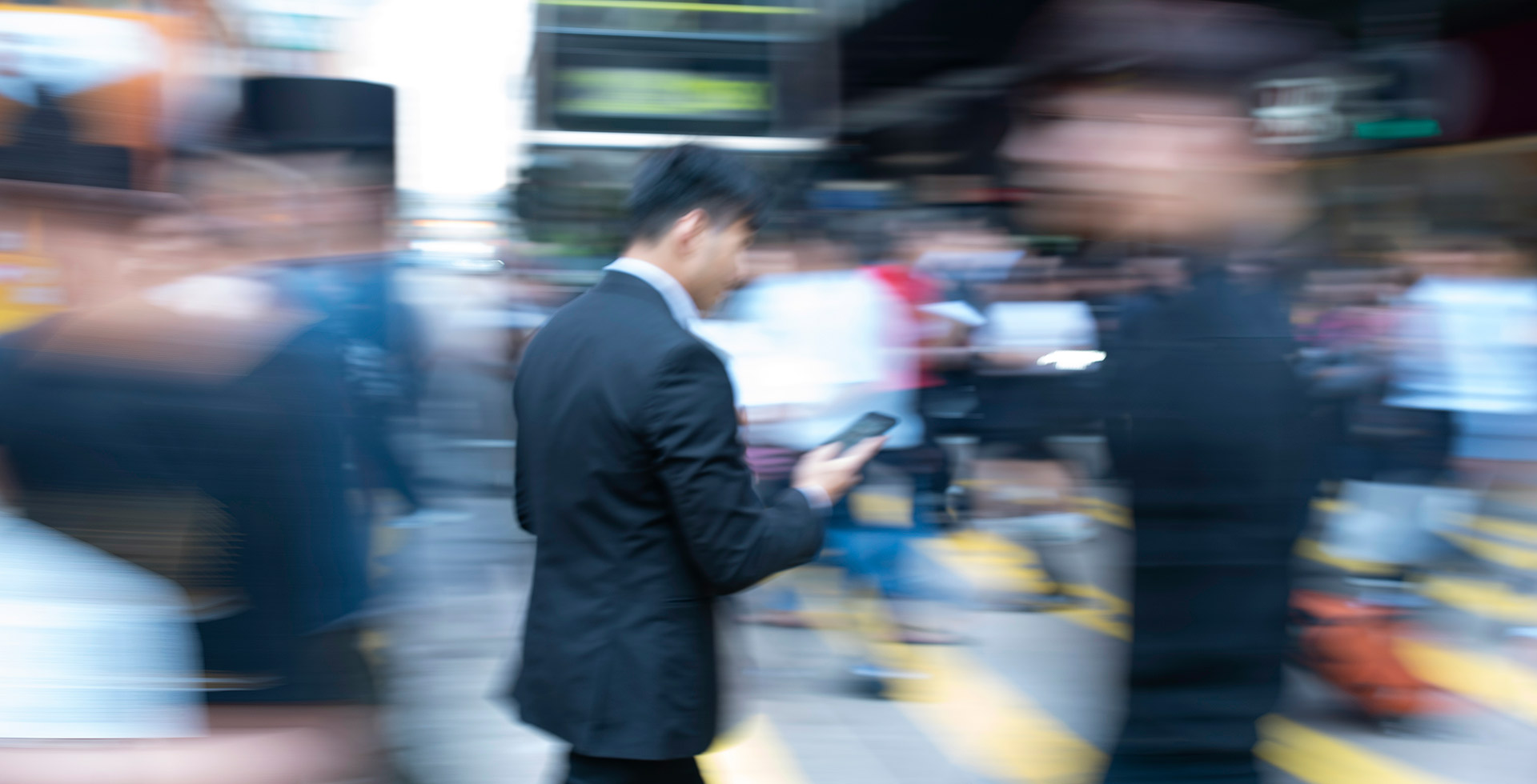 BussinesMan with mobile device in city center with blurred background