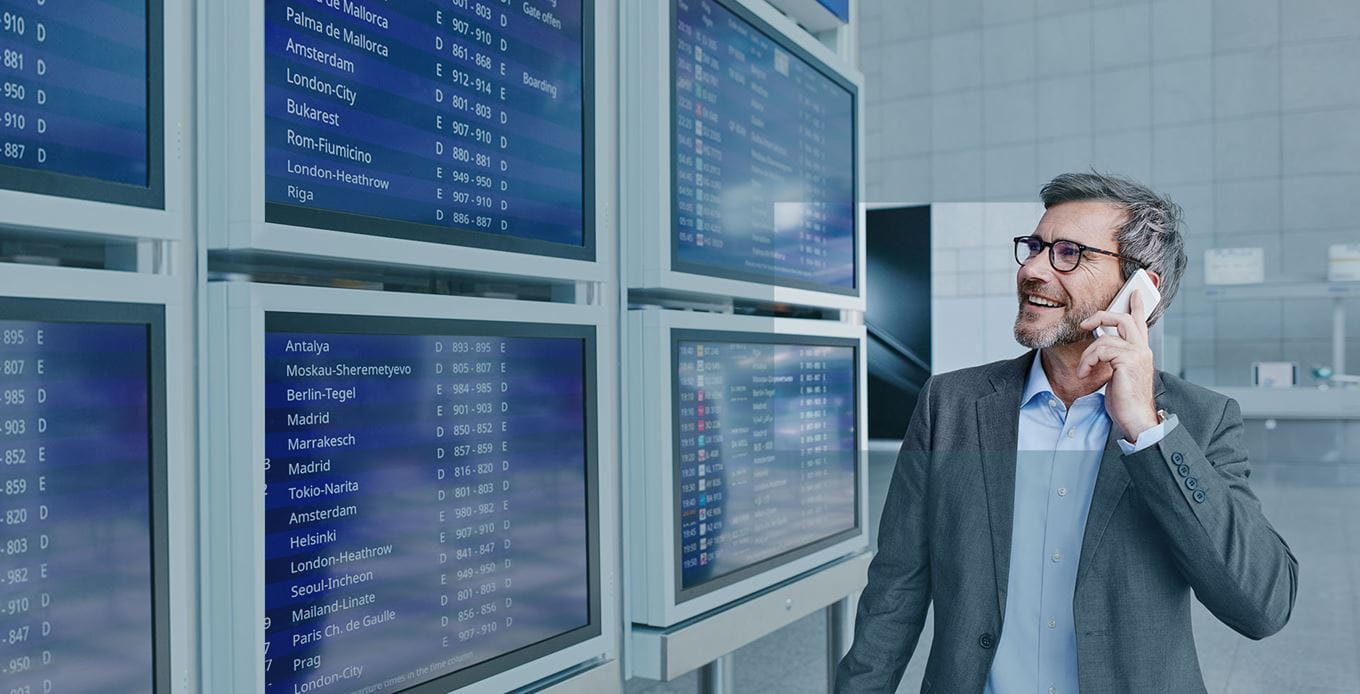 Man checks departures board in an airport