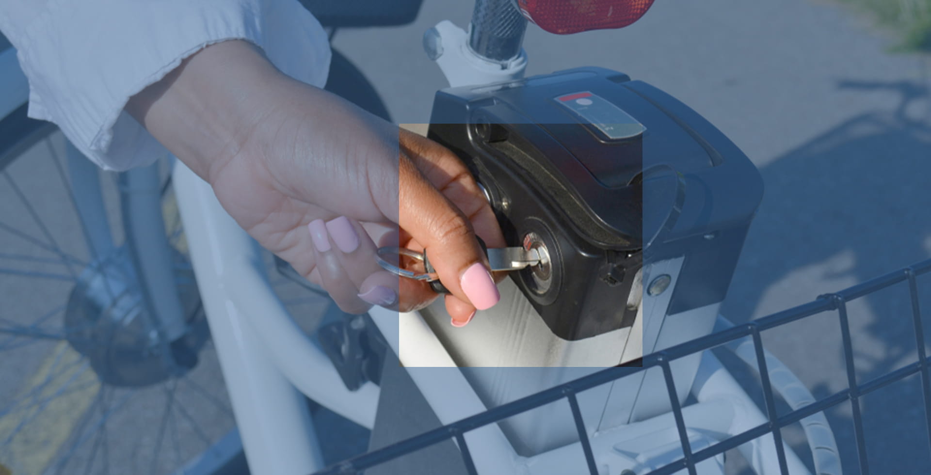 Woman unlocking battery on an e-bike