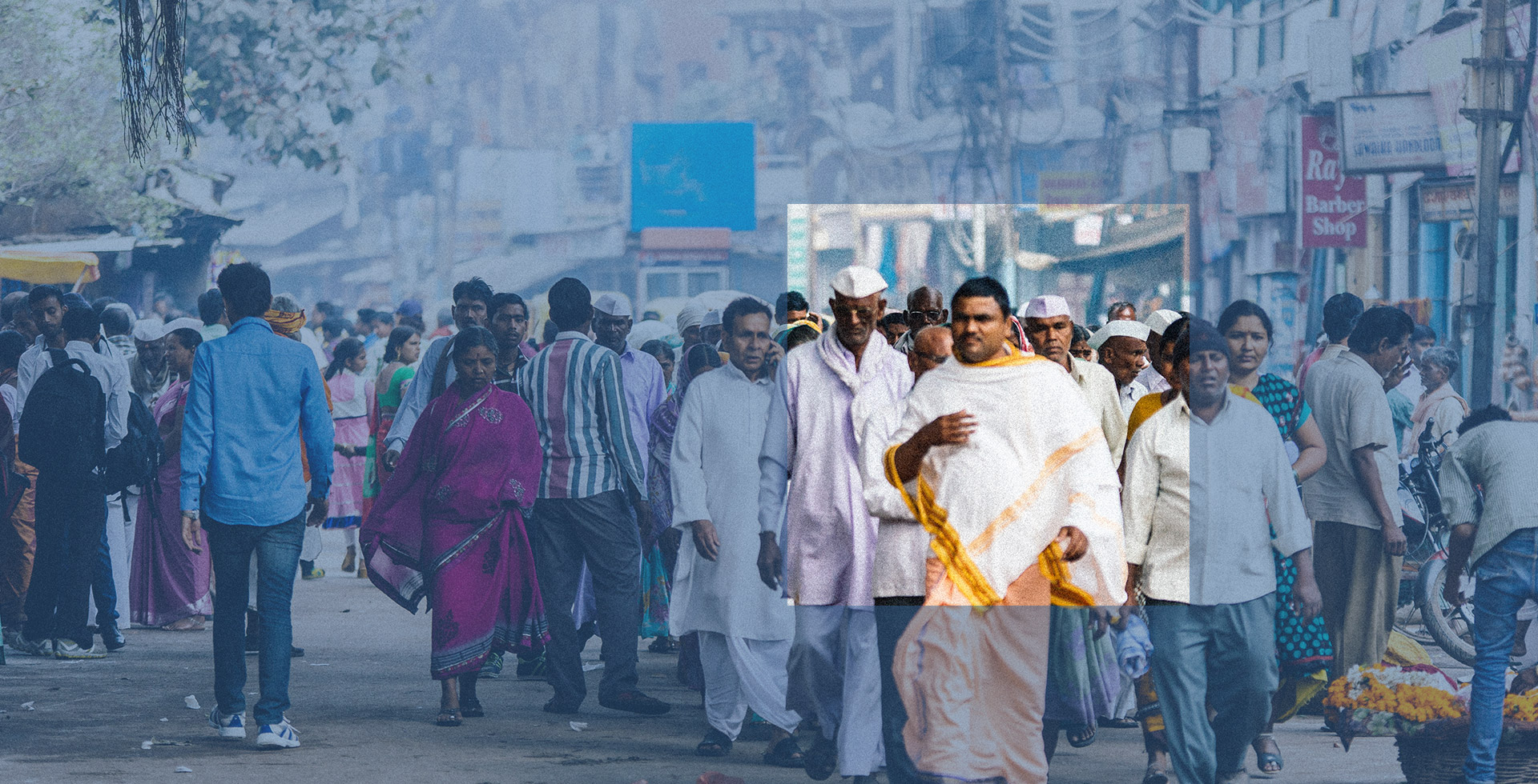 A crowd walks on a street in Varanasi, India