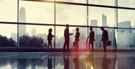 Business people meeting against a skyline