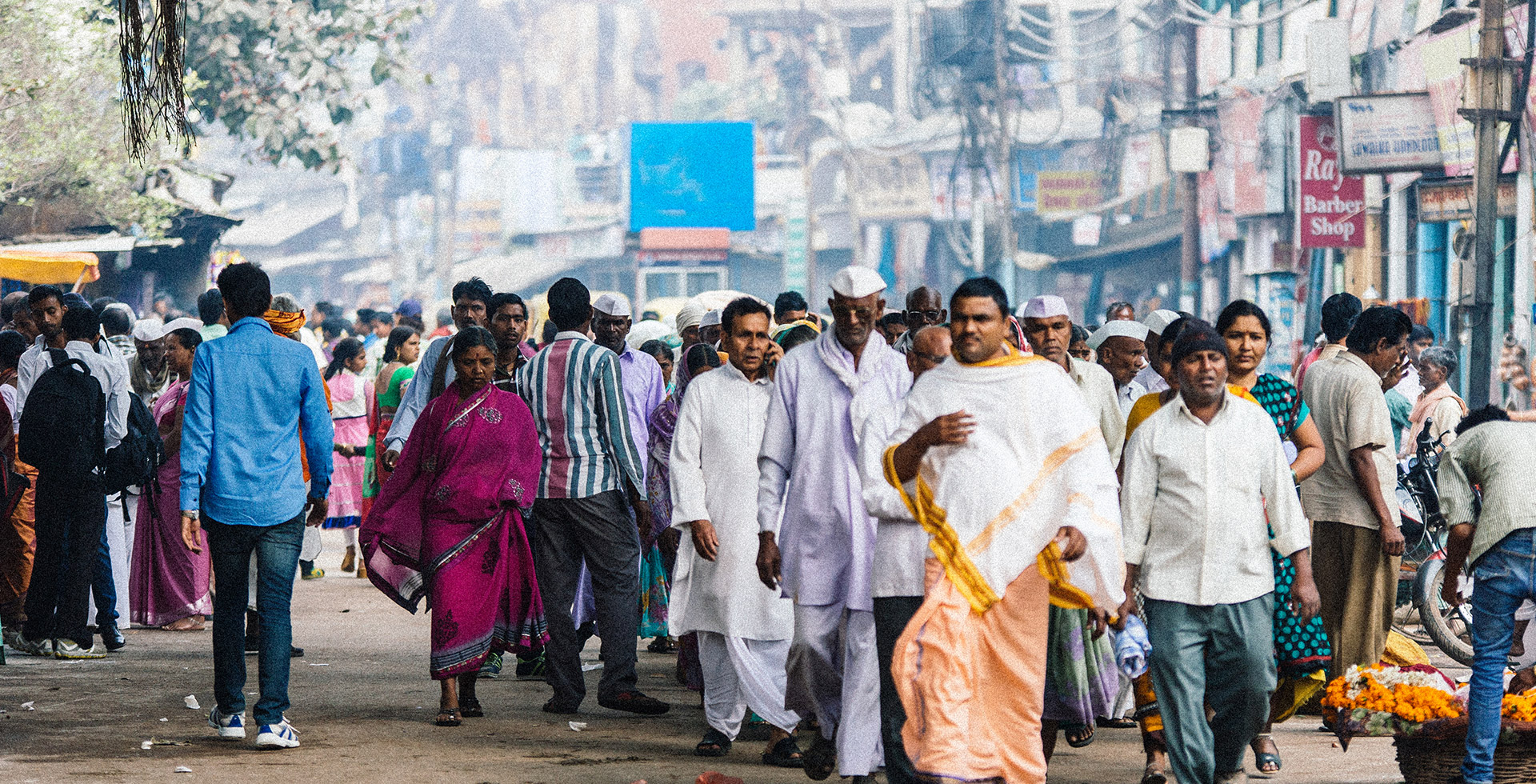 A crowd walks on a street in Varanasi, India