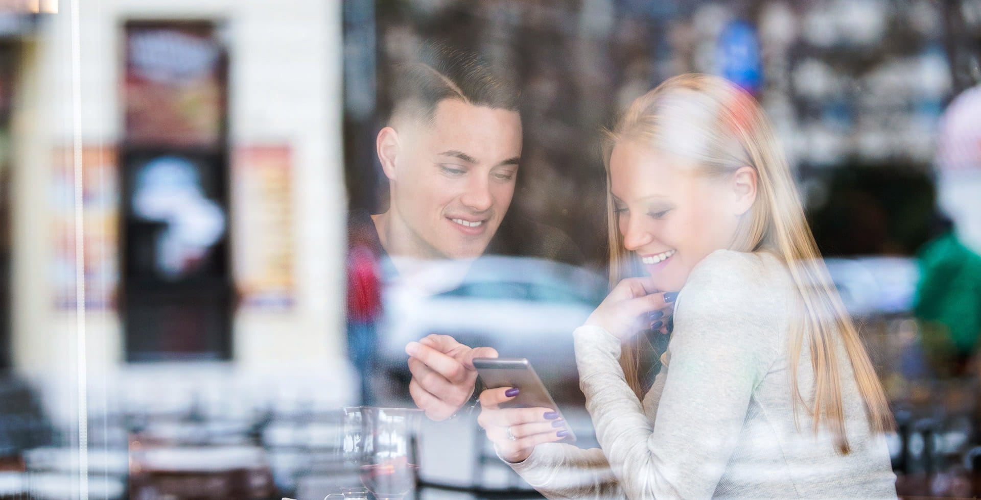 smiling couple looking at the phone